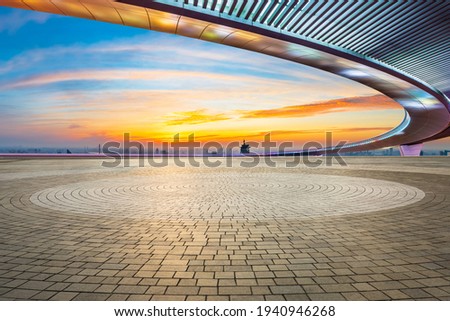 Empty square floor and city skyline at sunset in Shanghai.
