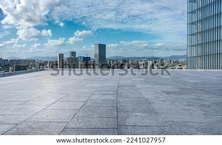 Empty square floor and city skyline with modern buildings in Ningbo, Zhejiang Province, China. 