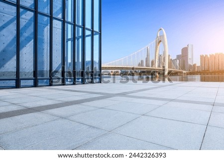Empty square floor and glass wall with city buildings in Guangzhou