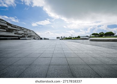 Empty square floor and modern architecture with blue sky background.