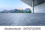 Empty square floor and modern city buildings scenery at sunset