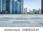 Empty square floor and modern city skyline with buildings under blue sky