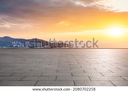 Empty square floor and modern city buildings with skyline by the sea