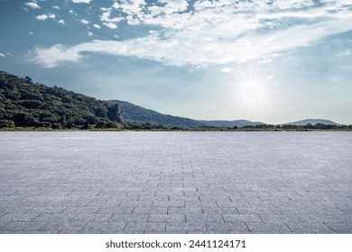 Empty square floor and mountains at sunset