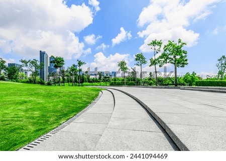 Empty square floor and trees with buildings in park