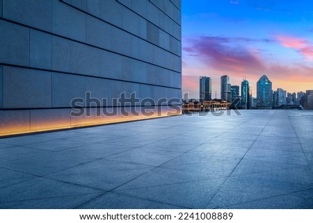 Empty square floor and wall building with city skyline in Shanghai at night, China.