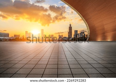 Empty square floor and wall with modern city skyline at sunset in Ningbo, Zhejiang Province, China.   