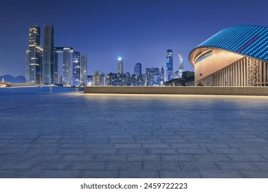 Empty square floors and modern city buildings at night in Chongqing - Powered by Shutterstock