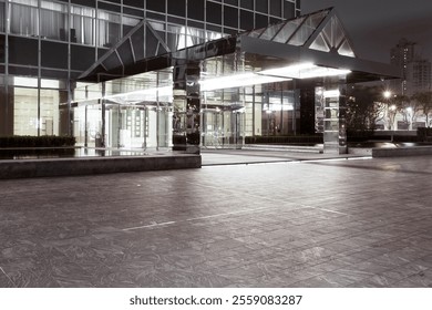 An empty square at the front of a shopping mall at night