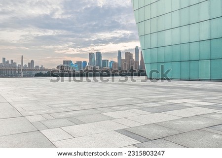 Empty square pavement and city buildings skyline