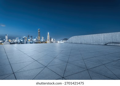 Empty square platform with a panoramic view of the modern city financial district skyline at night.