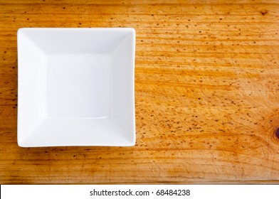 An Empty Square White Bowl On Timber