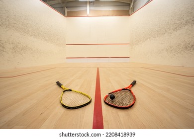 Empty squash court ultra-wide angle view. Racket and ball on the ground, no people. - Shutterstock ID 2208418939