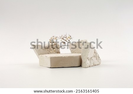 Empty stack of stones platform podium on beige gray background. Minimal empty display product presentation scene.