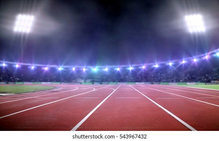 Empty Stadium With Running Track Under Spotlight At Night