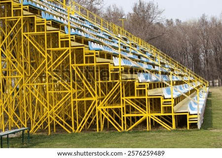Empty stadium seats before a game . Open air stands