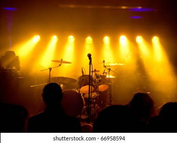 Empty Stage At Concert, Concert Crowd In Front Of Bright Yellow Stage Lights