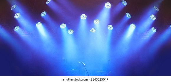 An Empty Stage - Evoking Anticipation. A Stage At A Music Festival With Lights Streaming Down From Above.