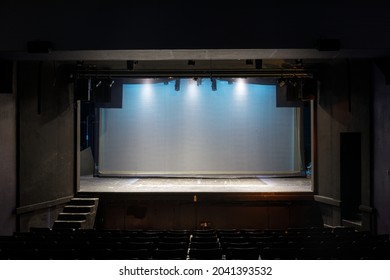 Empty Stage Lit In Blue Lights On Cyclorama And Yellow Spotlights