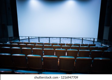 Empty Stage In The Small Movie Theater With White Isolated Screen