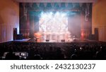 An empty stage of the theater, lit by spotlights and smoke before the performance