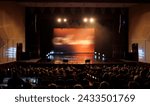 An empty stage of the theater, lit by spotlights and smoke before the performance