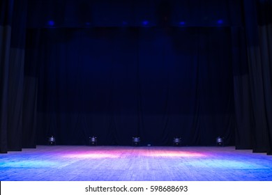 An empty stage of the theater, lit by spotlights before the performance
