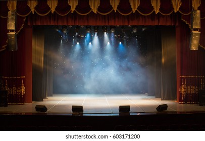 An empty stage of the theater, lit by spotlights and smoke before the performance - Shutterstock ID 603171200