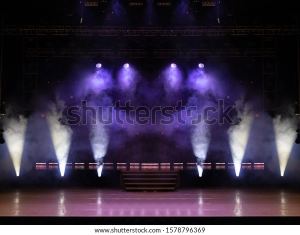 An empty stage of the theater, lit by
spotlights and smoke before the
performance