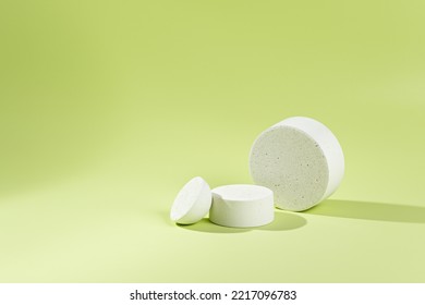 An Empty Stage With Three White Podiums Of Different Sizes On A Green Background And Shadows. Stand For Demonstration Of Models Of Cosmetic Products And Packages