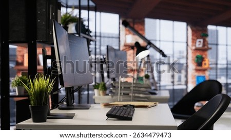 Empty startup office with PC on desk to be used by programmers building scalable solutions for businesses. AI industry startup workspace leveraging machine learning technology