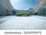 Empty stone paved square in front of modern curved office buildings. Business architecture and urban space background.