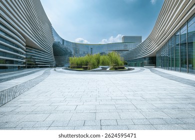 Empty stone paved square in front of modern curved office buildings. Business architecture and urban space background.