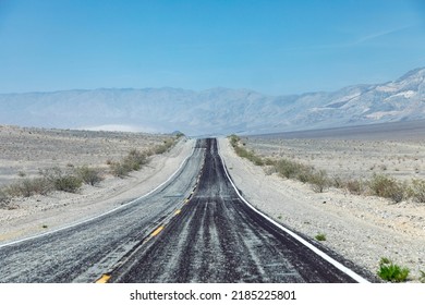 Empty Straight Road Thru The Death Valley With Yellow Median, USA