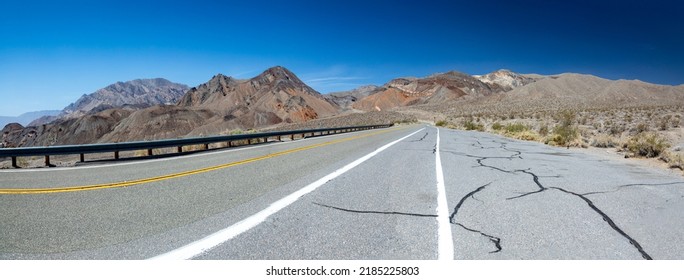 Empty Straight Road Thru The Death Valley With Yellow Median, USA