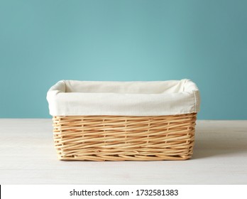 Empty straw basket with white linen on wooden table.Food container empty space. - Powered by Shutterstock