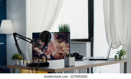 Empty Streaming Studio Booth With Modern Professional Audio Equipment. Podcast Broadcast Desk Having Recording Devices And Gadgets Inside Office Workspace With Nobody In It. Studio Shot