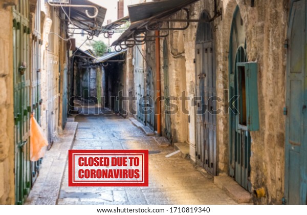 The empty street with closed shops in the Old\
City of Jerusalem. Following the coronavirus outbreak, the Israeli\
Government has decided for a massive curfew, leaving the Old Town\
totally deserted.