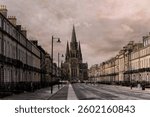 Empty street with historic buildings leading to St Mary