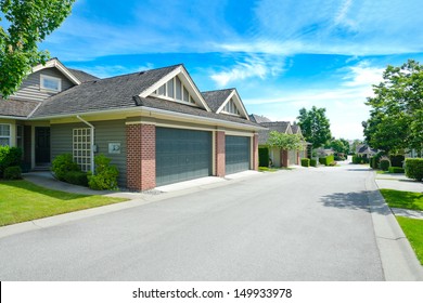 Empty Street Of The Nice Neighborhood With Double Doors Garages In The Suburbs Of Vancouver, Canada.