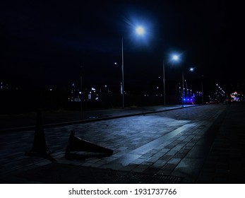 Empty Street At Night With Parking Cone