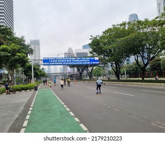 Empty Street On Sunday Car Free Day, Translate: Car Free Day, Right Lane For Transjakarta Bus Following By Cyclist, Runner And Walker On Left Lane Or Sidewalk