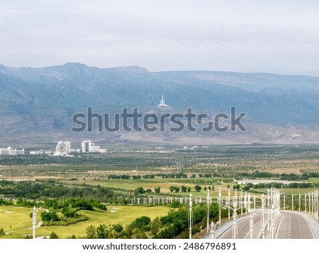 Empty Streets of Ashgabat on a cloudy morning with Alam Center and Turkmenistan TV Tower seen in the distance