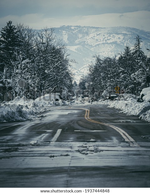 empty streets during the snow storm\
with the foot hills of the mountains in the background\
\
