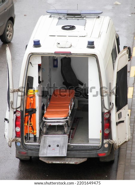 An empty\
stretcher in an ambulance car top\
view