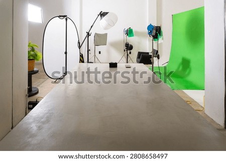 Empty studio with green screen background and professional lighting equipment for video production