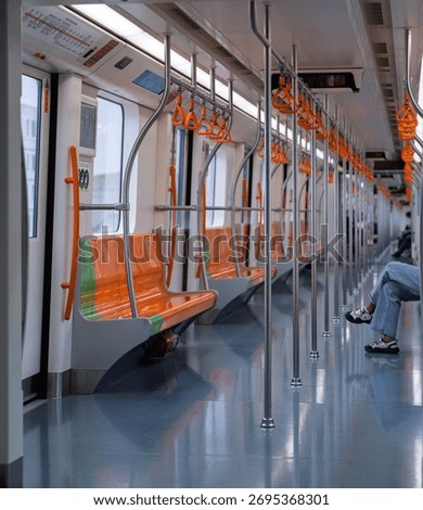 Empty subway interior with orange seats