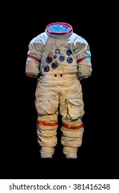 Empty Suit Of An Astronaut On A Black Background. Old Protective Space Suit For Cosmonaut. Used Spacesuit On Dark Background. 