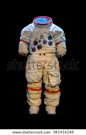 Empty suit of an astronaut on a black background. Old protective space suit for cosmonaut. Used spacesuit on dark background. 