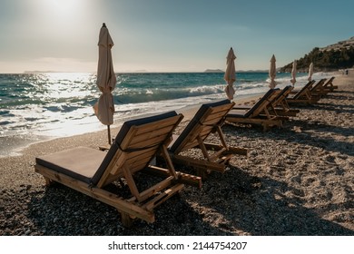 Empty Sunbeds On Beach No People